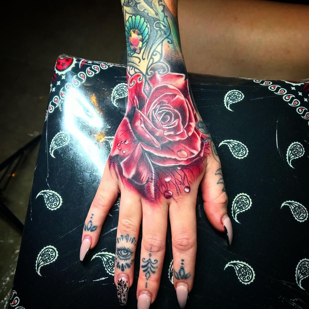 rose tattoo on hand