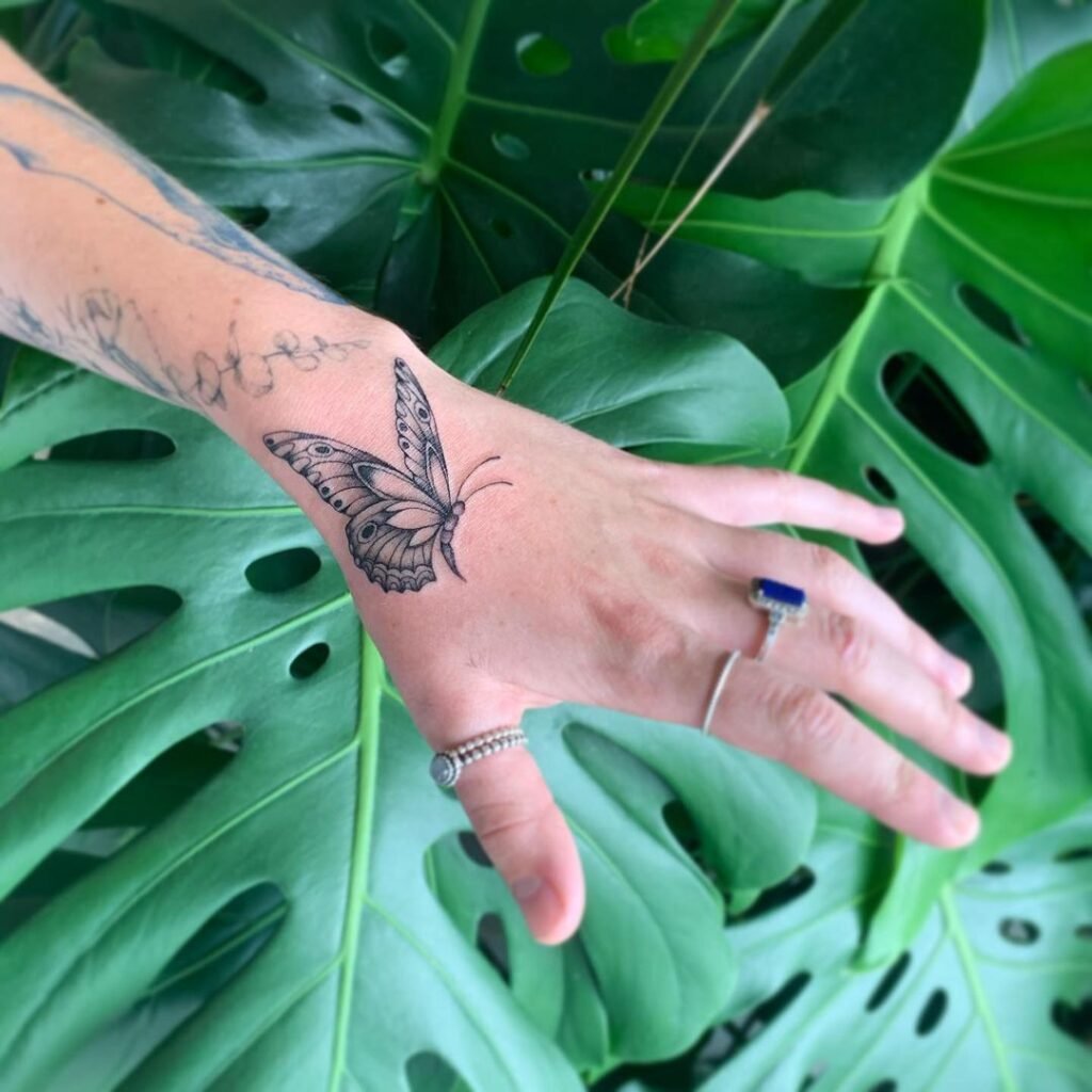 hand butterfly tattoo