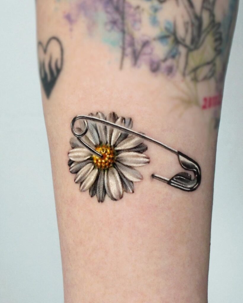 minimalist daisy tattoo