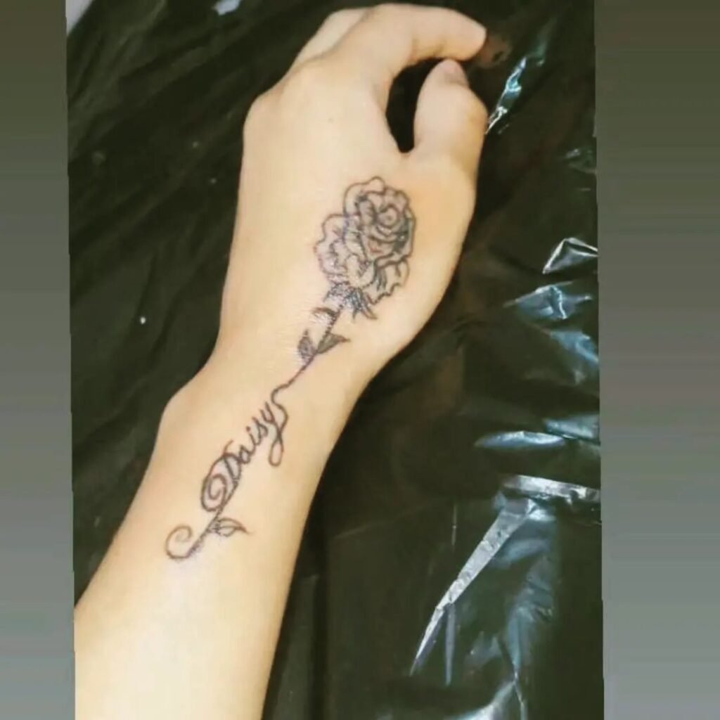 wrist daisy tattoo