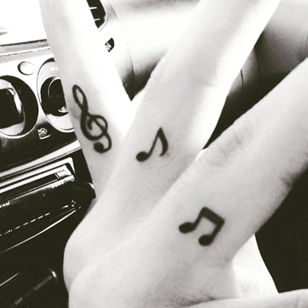 finger muscnote tattoos